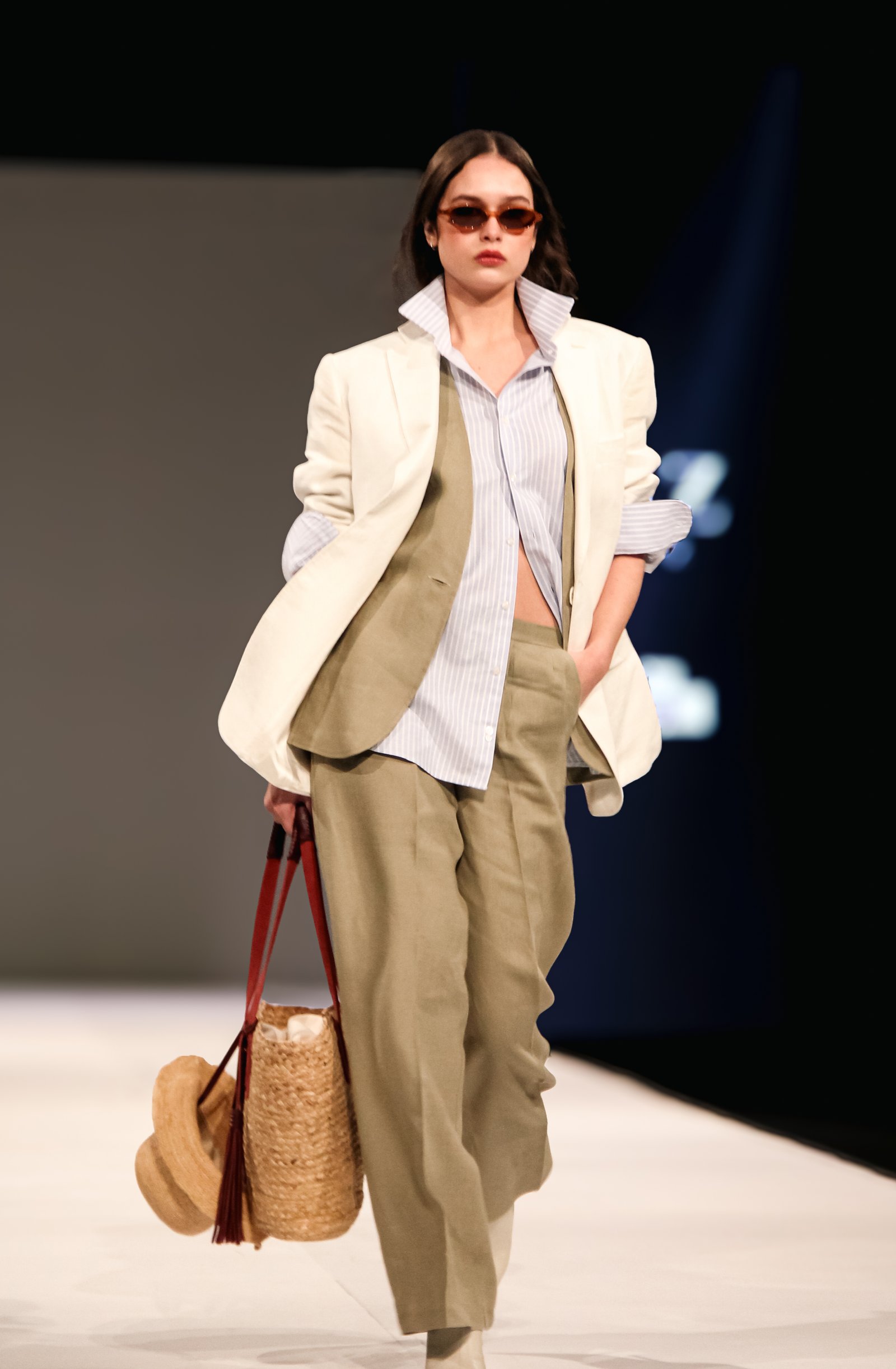 Modelo en pasarela con blazer crudo y pantalón beige